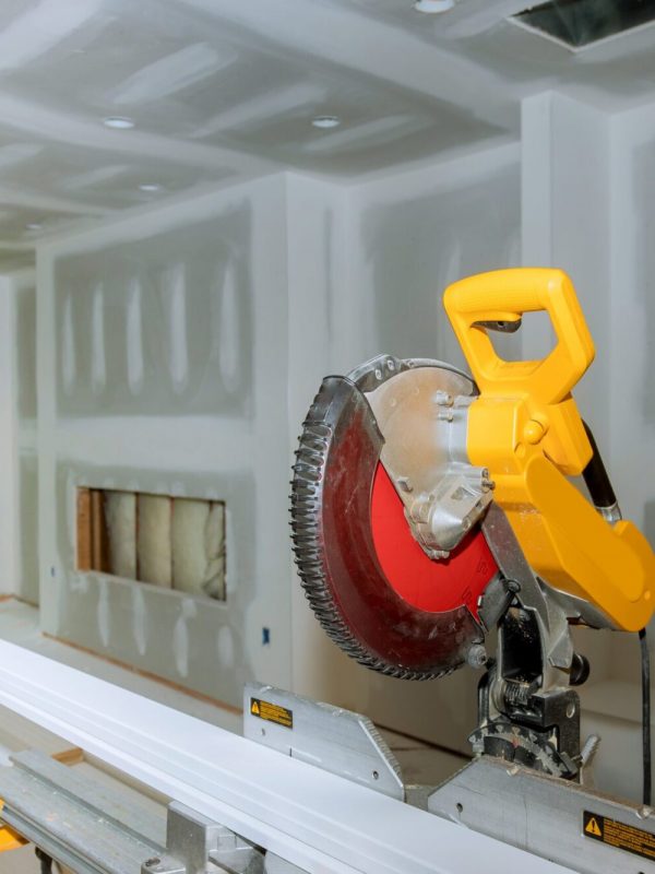 Circular saw cutting wooden base molding new home installing construction building industry remodel